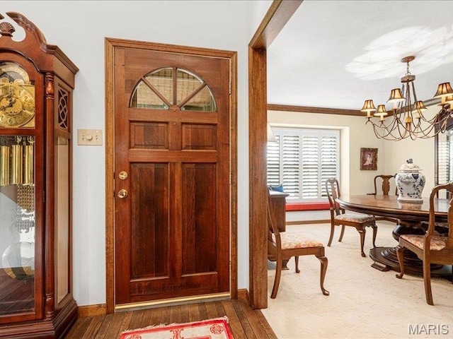 2254 Ridgley Woods Dr, Chesterfield, MO 63005 - entrance foyer with a chandelier, plenty of natural light, baseboards, and wood finished floors