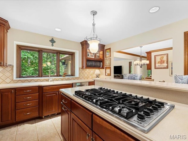 2254 Ridgley Woods Dr, Chesterfield, MO 63005 - kitchen featuring appliances with stainless steel finishes, a chandelier, light countertops, backsplash, and hanging light fixtures