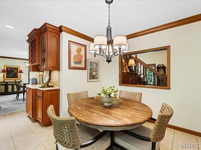 2254 Ridgley Woods Dr, Chesterfield, MO 63005 - dining room featuring light tile patterned floors, a chandelier, crown molding, stairs, and baseboards