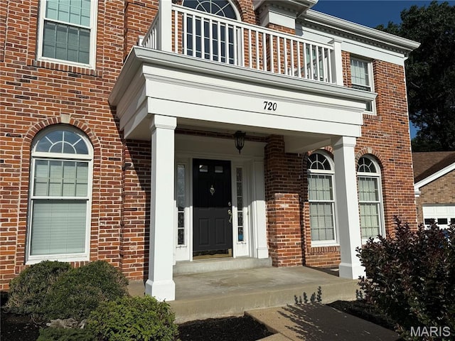 720 Woodridge Heights Ct, Manchester, MO 63011 - view of exterior entry featuring a balcony and brick siding