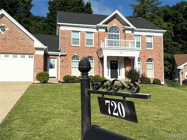 720 Woodridge Heights Ct, Manchester, MO 63011 - colonial home featuring a front yard, brick siding, concrete driveway, an attached garage, and a shingled roof