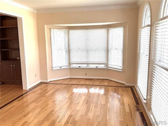 720 Woodridge Heights Ct, Manchester, MO 63011 - unfurnished room featuring light wood-type flooring, ornamental molding, and healthy amount of natural light