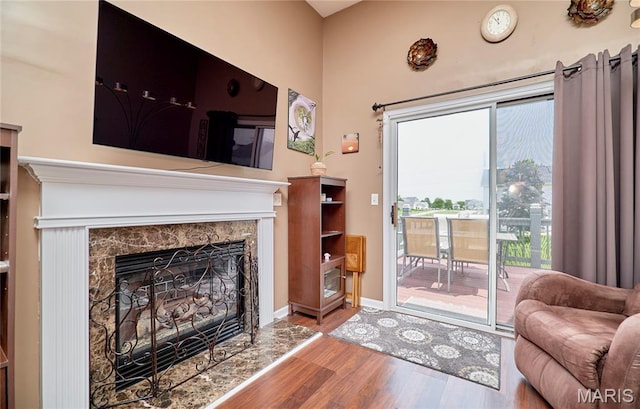 228 Centerfield Dr, Ofallon, MO 63366 - living room featuring wood finished floors, a fireplace, and plenty of natural light