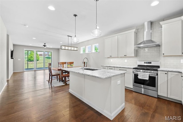 14 Ivyleigh Ct, Saint Charles, MO 63303 - kitchen featuring gas stove, wall chimney range hood, plenty of natural light, decorative backsplash, and recessed lighting