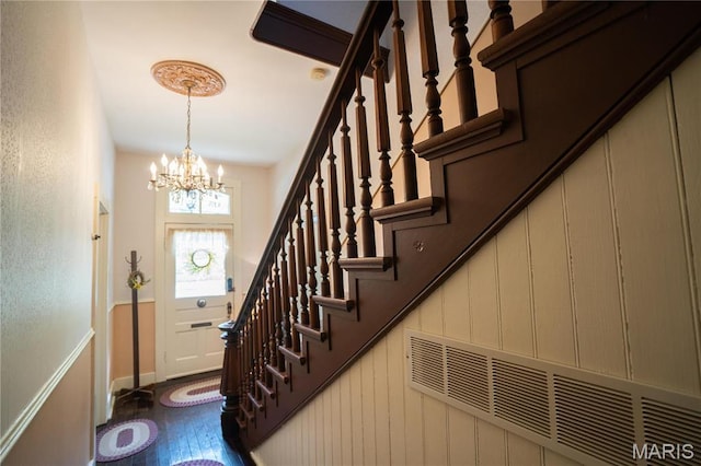 415 E 1st St, Hermann, MO 65041 - stairway featuring a chandelier and baseboards