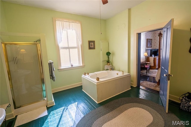 415 E 1st St, Hermann, MO 65041 - full bathroom featuring a stall shower, a bath, wood-type flooring, and a ceiling fan