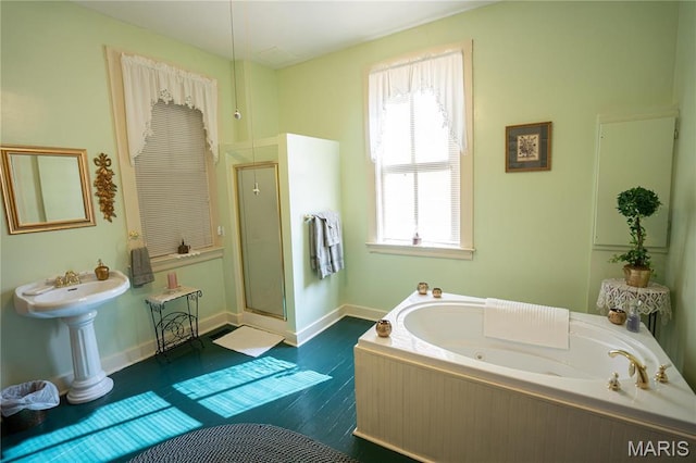 415 E 1st St, Hermann, MO 65041 - full bath featuring a jetted tub, plenty of natural light, wood finished floors, and a shower with door