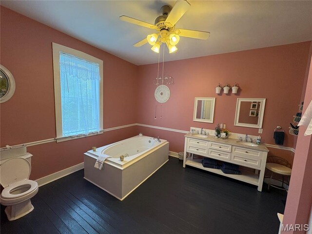 415 E 1st St, Hermann, MO 65041 - full bath featuring a whirlpool tub, a ceiling fan, wood-type flooring, and double vanity