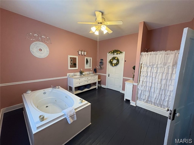 415 E 1st St, Hermann, MO 65041 - full bathroom with a whirlpool tub, ceiling fan, vanity, and hardwood / wood-style flooring
