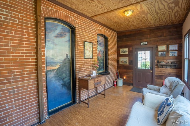 415 E 1st St, Hermann, MO 65041 - entryway with wooden ceiling, wood finished floors, wood walls, and brick wall