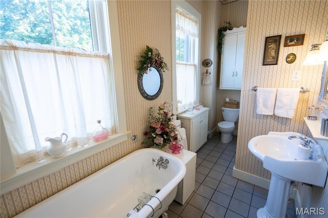 415 E 1st St, Hermann, MO 65041 - bathroom with wallpapered walls, tile patterned floors, and a freestanding bath