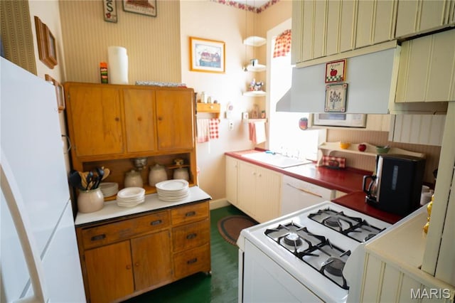 415 E 1st St, Hermann, MO 65041 - kitchen with white appliances, open shelves, light countertops, and decorative light fixtures