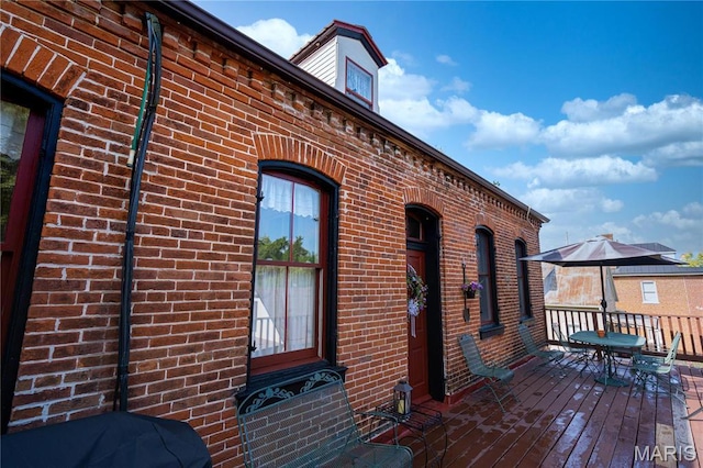 415 E 1st St, Hermann, MO 65041 - view of exterior entry featuring brick siding and a wooden deck