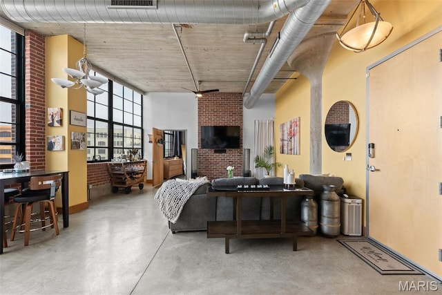 2323 Locust St Unit 308, Saint Louis, MO 63103 - living room with a high ceiling, healthy amount of natural light, concrete flooring, and baseboards