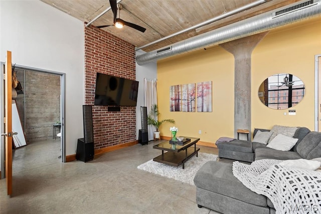 2323 Locust St Unit 308, Saint Louis, MO 63103 - living area with a ceiling fan, a towering ceiling, finished concrete floors, and baseboards