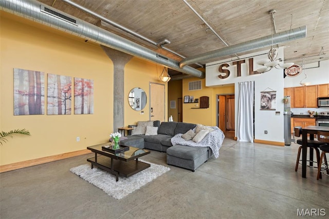 2323 Locust St Unit 308, Saint Louis, MO 63103 - living area with a high ceiling, finished concrete floors, and baseboards