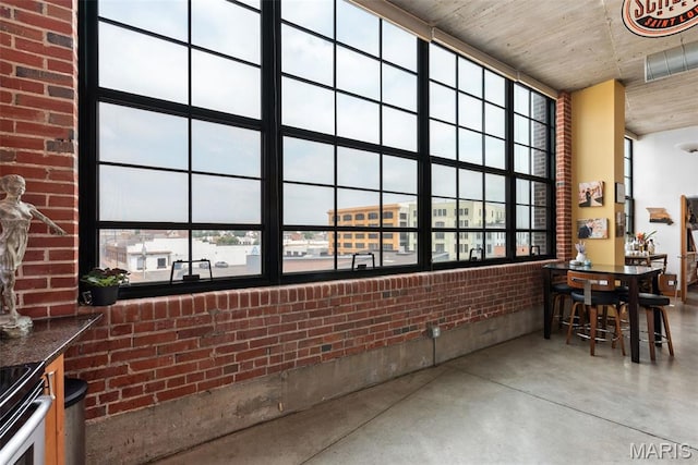 2323 Locust St Unit 308, Saint Louis, MO 63103 - sunroom with brick wall and concrete flooring