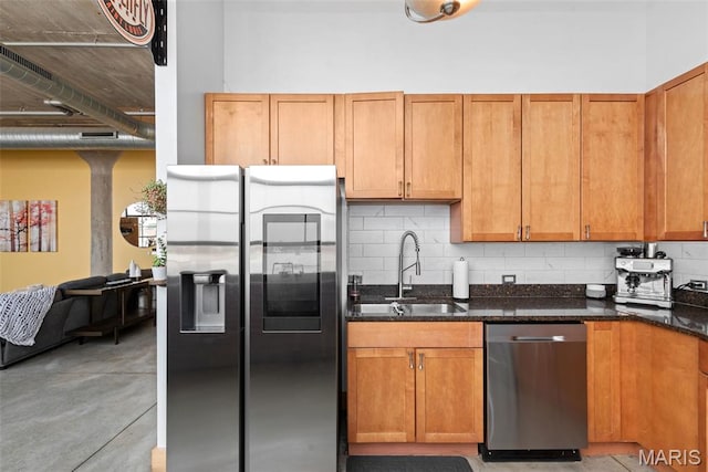 2323 Locust St Unit 308, Saint Louis, MO 63103 - kitchen featuring stainless steel appliances, tasteful backsplash, dark stone counters, and a sink