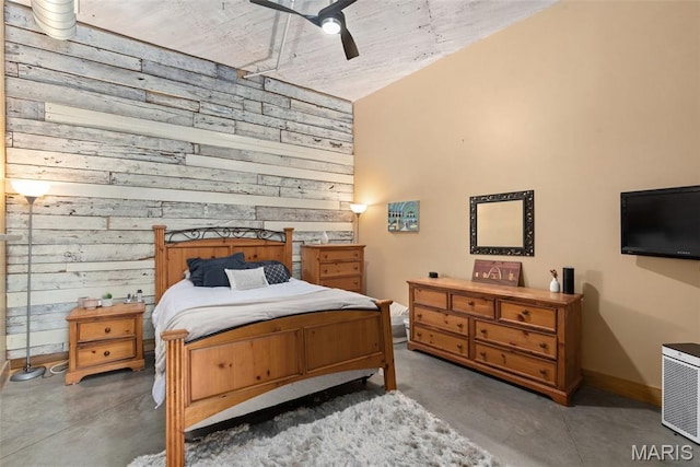 2323 Locust St Unit 308, Saint Louis, MO 63103 - bedroom with concrete flooring, wood walls, baseboards, a high ceiling, and a ceiling fan