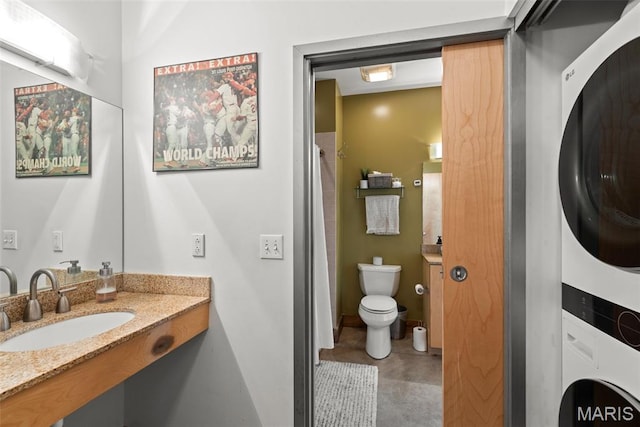 2323 Locust St Unit 308, Saint Louis, MO 63103 - full bathroom with stacked washer / dryer, toilet, and vanity