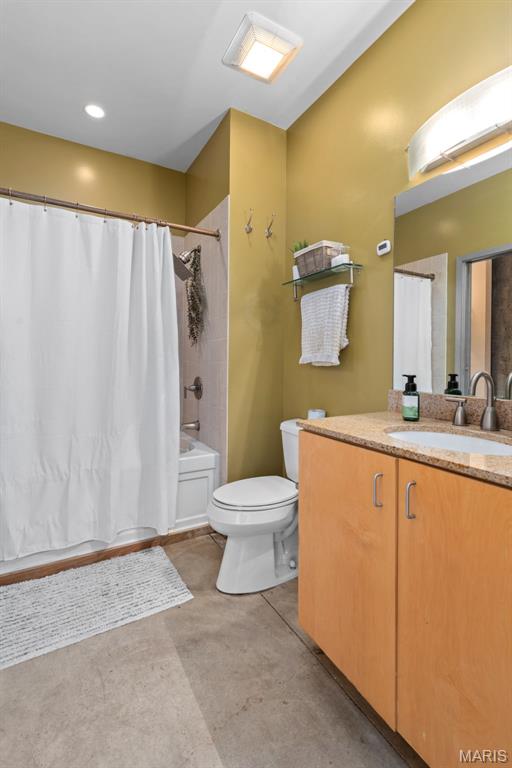 2323 Locust St Unit 308, Saint Louis, MO 63103 - bathroom featuring toilet, vanity, shower / tub combo with curtain, and concrete flooring