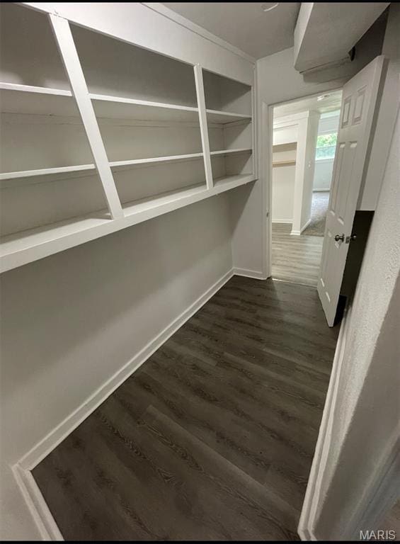 hall with dark wood finished floors and baseboards