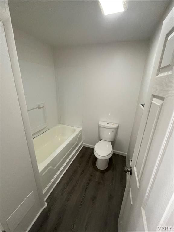bathroom with a tub and wood finished floors