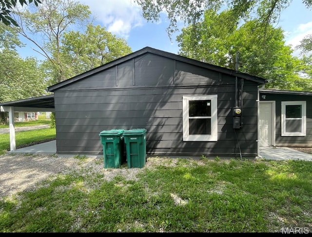 view of side of home featuring a yard