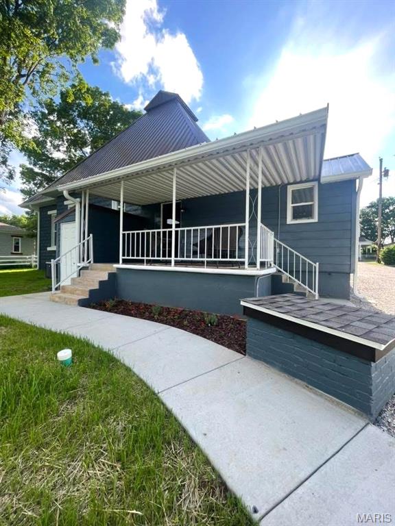 10216 High St, Belgrade, MO 63622 - view of front facade featuring a porch and metal roof