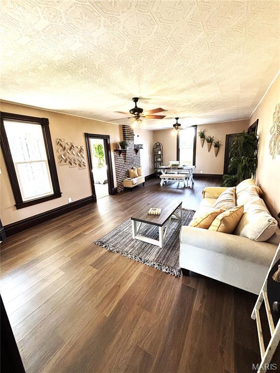 10216 High St, Belgrade, MO 63622 - living room with ceiling fan, wood finished floors, and baseboards