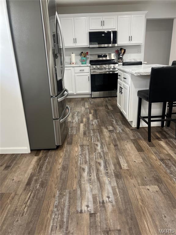403 E Summit St, Doniphan, MO 63935 - kitchen with stainless steel appliances, dark wood-type flooring, and white cabinetry