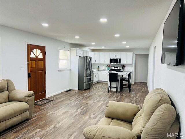 403 E Summit St, Doniphan, MO 63935 - living area featuring recessed lighting, light wood-style floors, and baseboards