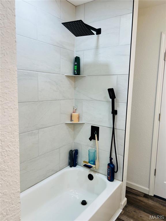 403 E Summit St, Doniphan, MO 63935 - bathroom featuring wood finished floors, shower / bath combination, and baseboards