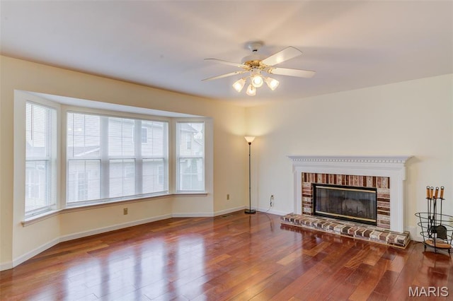 12118 Fahrpark Ln, Saint Louis, MO 63146 - unfurnished living room featuring wood-type flooring, a ceiling fan, baseboards, and a brick fireplace