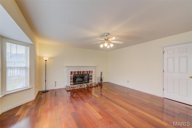 12118 Fahrpark Ln, Saint Louis, MO 63146 - living room featuring ceiling fan, wood finished floors, a brick fireplace, and baseboards