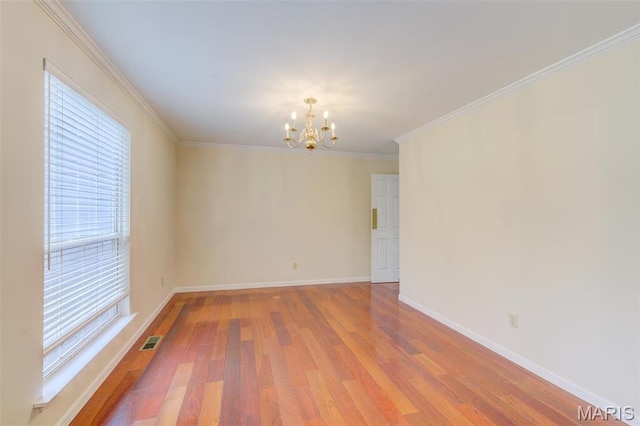 12118 Fahrpark Ln, Saint Louis, MO 63146 - unfurnished room with a chandelier, light wood-type flooring, baseboards, and crown molding