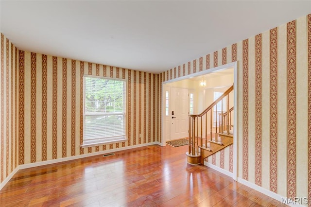 12118 Fahrpark Ln, Saint Louis, MO 63146 - unfurnished room featuring hardwood / wood-style floors, stairs, and baseboards