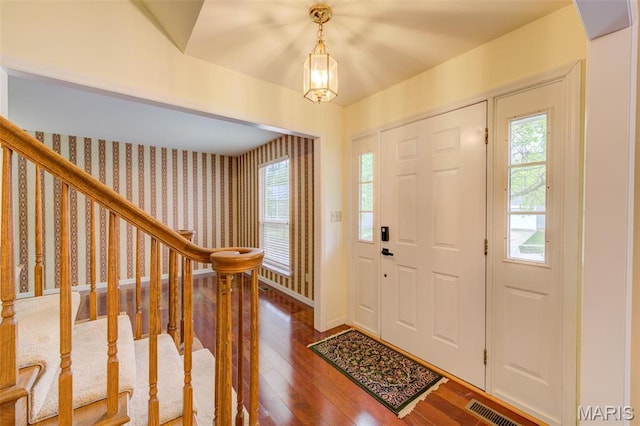 12118 Fahrpark Ln, Saint Louis, MO 63146 - entrance foyer featuring hardwood / wood-style floors, wallpapered walls, stairway, and baseboards