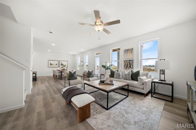 3063 Pirogue St, Saint Charles, MO 63301 - living area featuring wood finished floors, a ceiling fan, baseboards, stairway, and recessed lighting