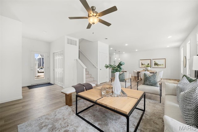 3063 Pirogue St, Saint Charles, MO 63301 - living room featuring stairs, light wood-type flooring, recessed lighting, a ceiling fan, and plenty of natural light