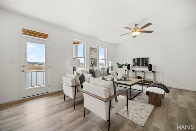 3063 Pirogue St, Saint Charles, MO 63301 - living room featuring wood finished floors, ceiling fan, and baseboards