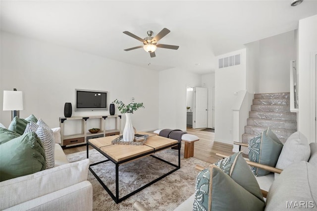 3063 Pirogue St, Saint Charles, MO 63301 - living area featuring ceiling fan, light wood-style flooring, stairway, and baseboards