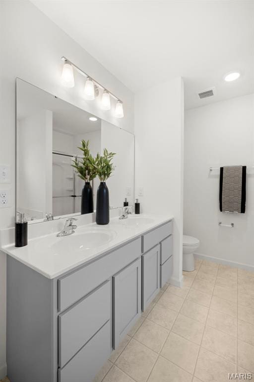 3063 Pirogue St, Saint Charles, MO 63301 - bathroom featuring double vanity, toilet, tile patterned floors, and baseboards