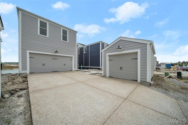 3063 Pirogue St, Saint Charles, MO 63301 - view of front of house with an outbuilding, driveway, and a detached garage