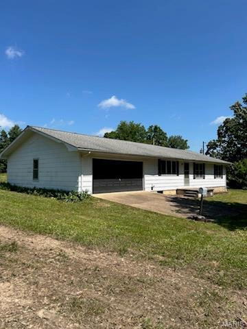 18795 S US Highway 63, Rolla, MO 65401 - view of side of property featuring a garage, a lawn, and driveway