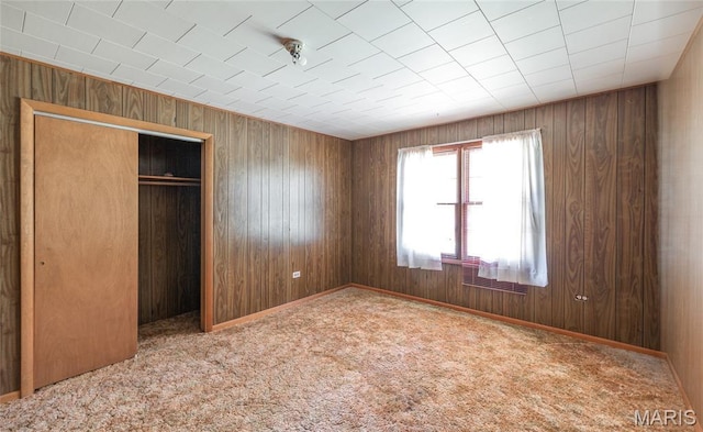 18795 S US Highway 63, Rolla, MO 65401 - unfurnished bedroom with wooden walls, a closet, and carpet