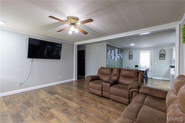 108 Karen St, Sikeston, MO 63801 - living room with ceiling fan, wood finished floors, baseboards, ornamental molding, and a textured ceiling