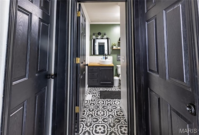108 Karen St, Sikeston, MO 63801 - half bathroom with crown molding, vanity, tile patterned floors, and toilet