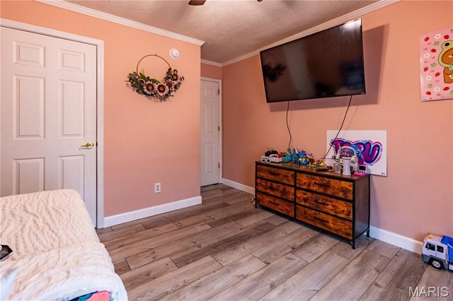 108 Karen St, Sikeston, MO 63801 - sitting room featuring wood finished floors, ornamental molding, a textured ceiling, and baseboards