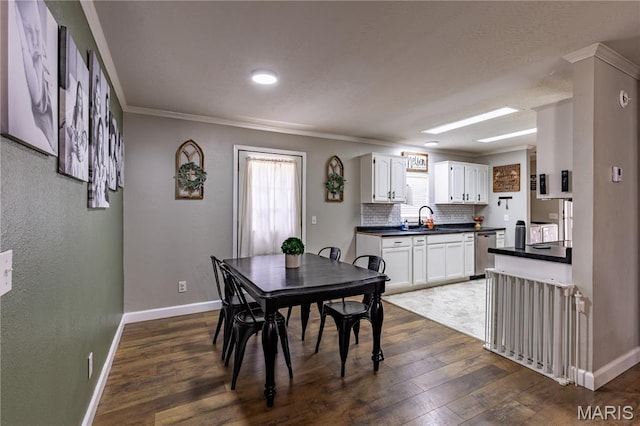 108 Karen St, Sikeston, MO 63801 - dining area with dark wood-type flooring, baseboards, and crown molding